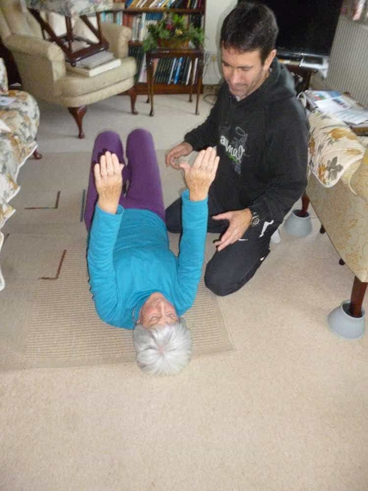 Older lady on floor having physiotherapy by Andy Gamble